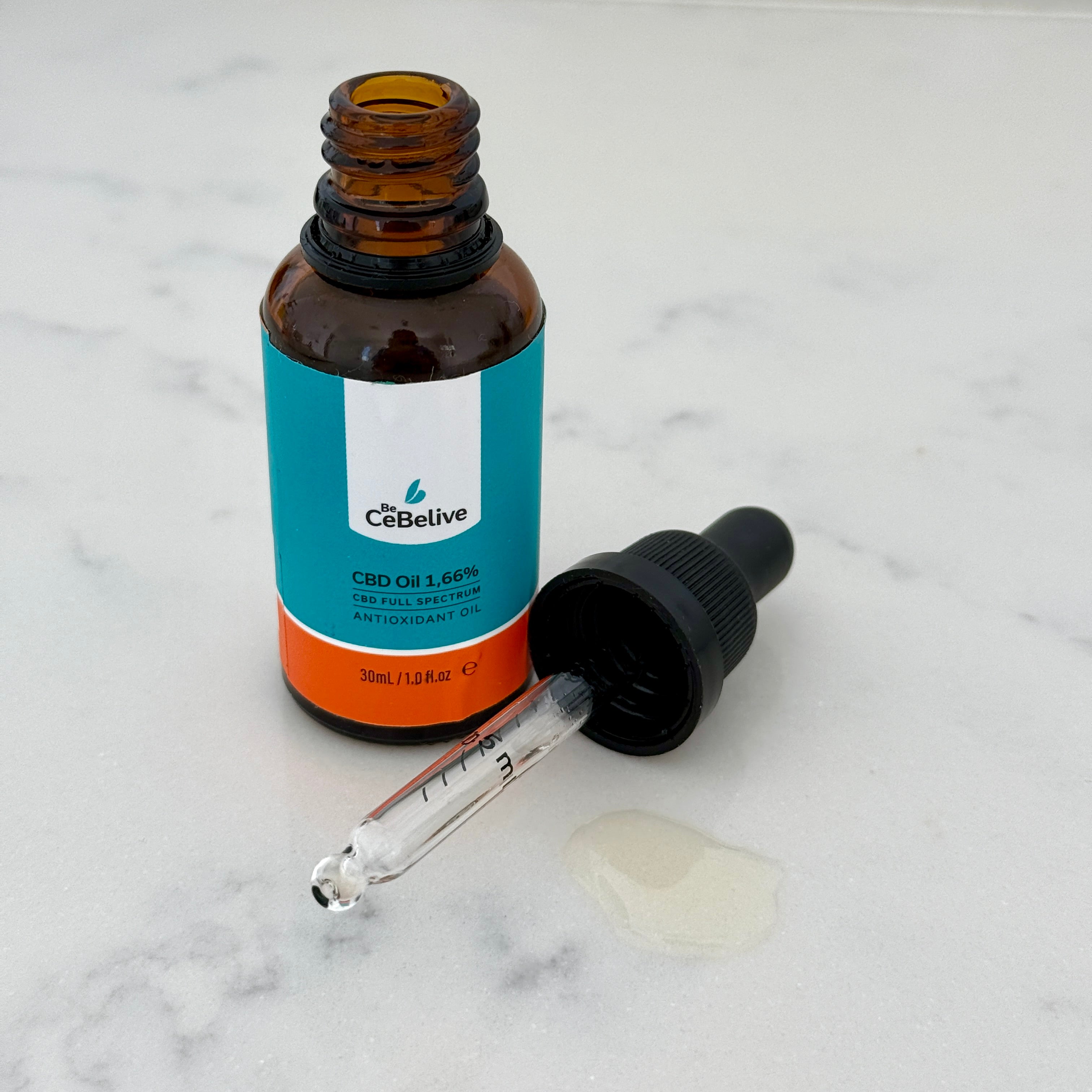 Off the Grind Daytime Balance 1.66% full-spectrum CBD oil bottle with graduated dropper on marble surface